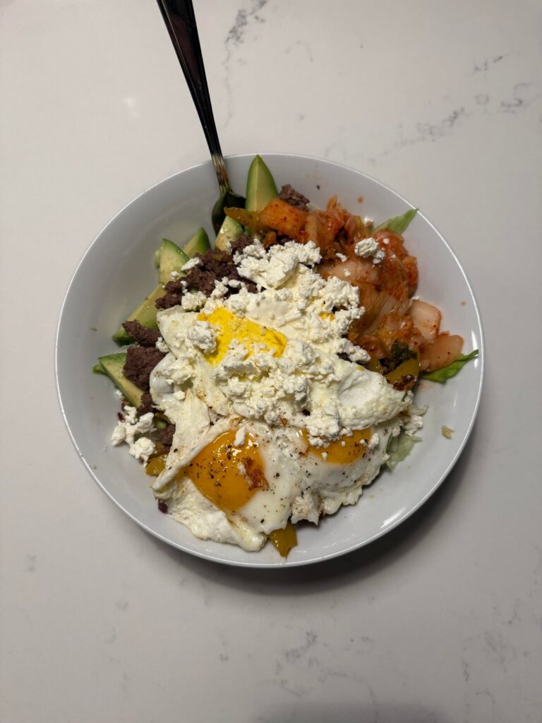 Korean fusion: ground beef, kimchi, avocado, fried eggs & feta