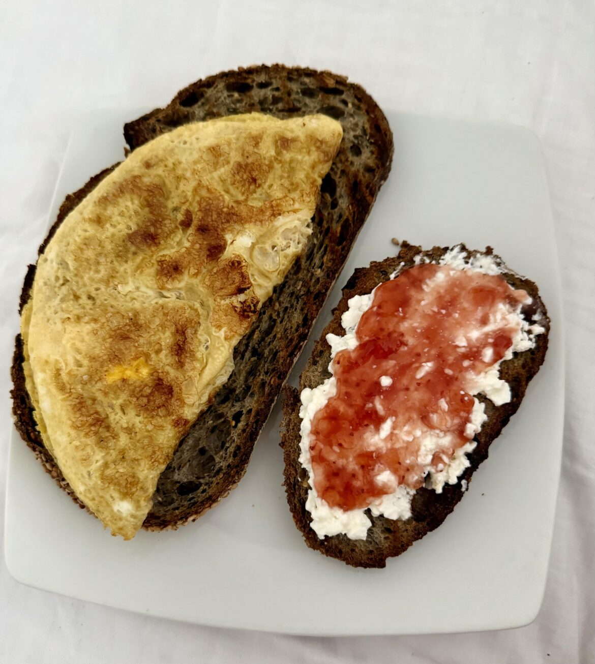 [Homemade] seeded bread with omelette, and cottage cheese topped with strawberry marmalade