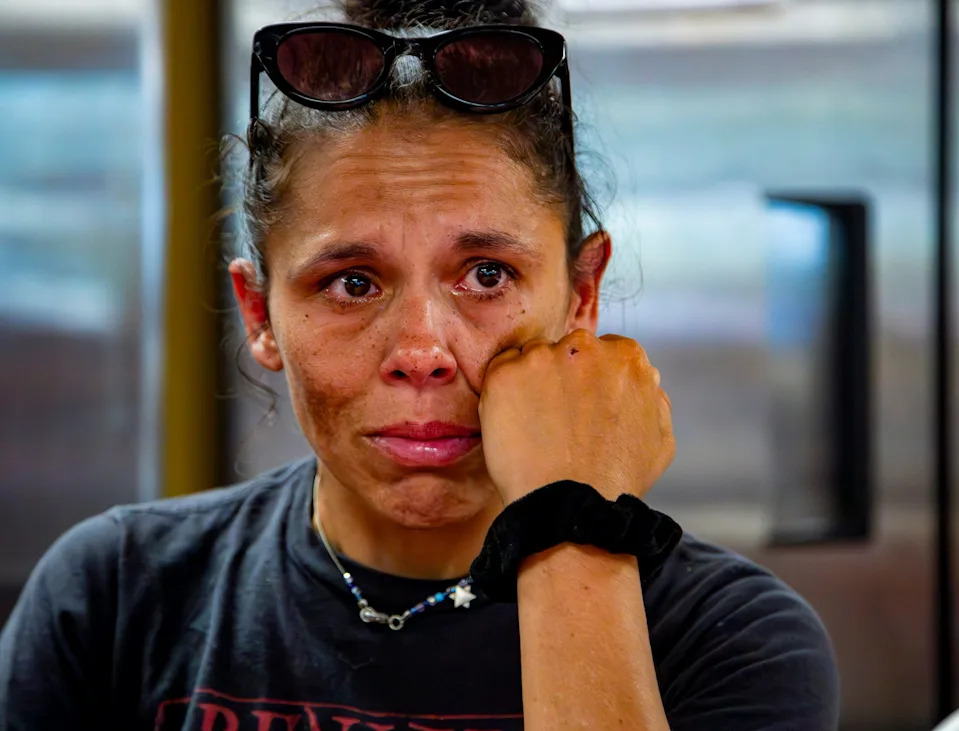 Asheville resident Glenda Naba wipes away a tear while talking with the Asheville Citizen Times inside 12 Baskets in West Asheville, Aug. 25, 2025.