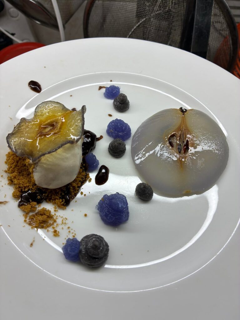 Glass pear, vanilla quenelle, butterfly pea gelée, black sesame paste