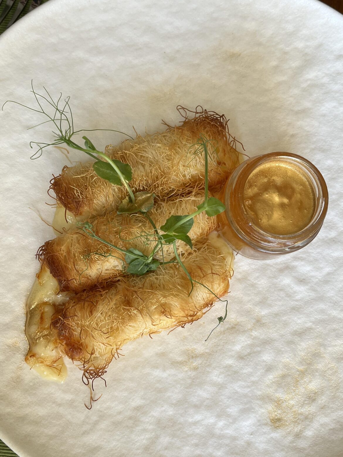 Yellow cheese in kadaif with sweets and golden spark Yellow cheese in kadaif with sweets and golden spark