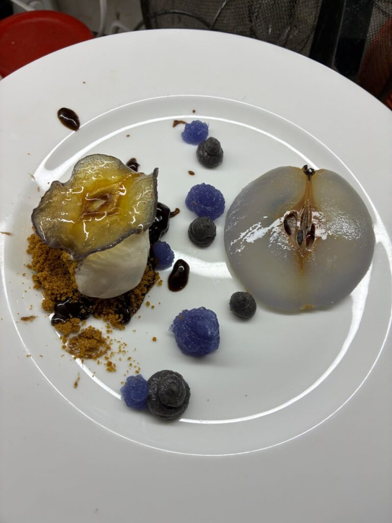 Glass pear, vanilla quenelle, butterfly pea gelée, black sesame paste