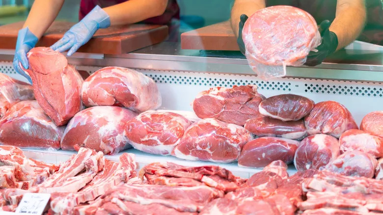 Butchers handling meat