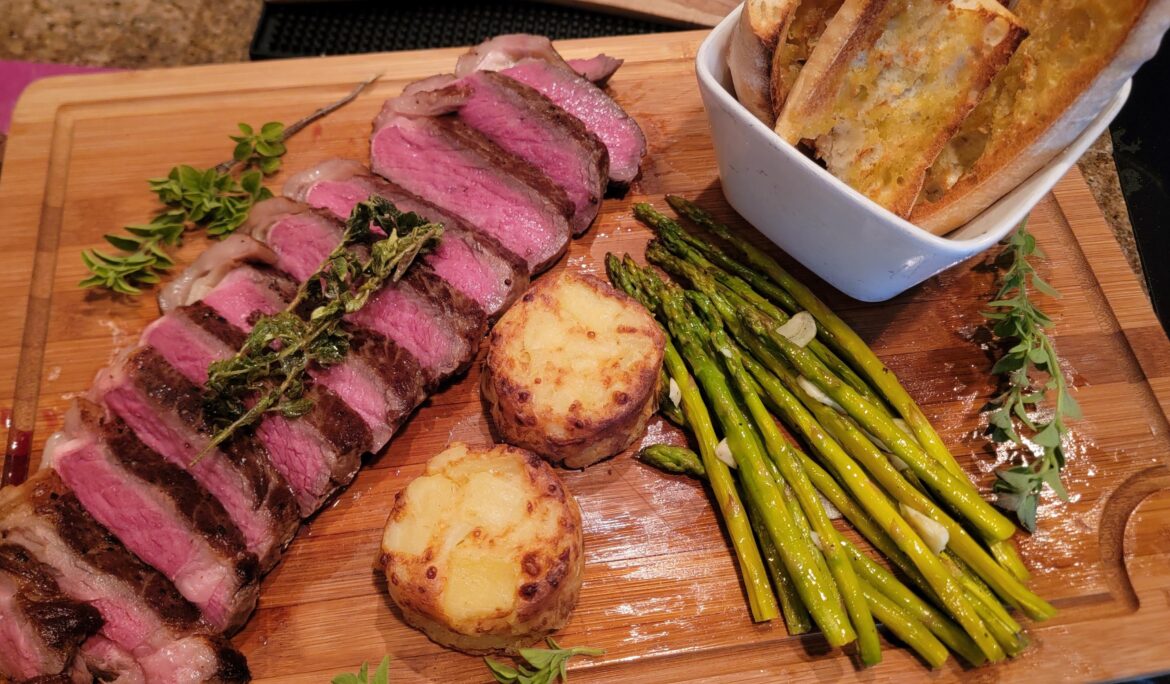 Homemade New York Prime Steak With Asparagus and Potatoes Gratin