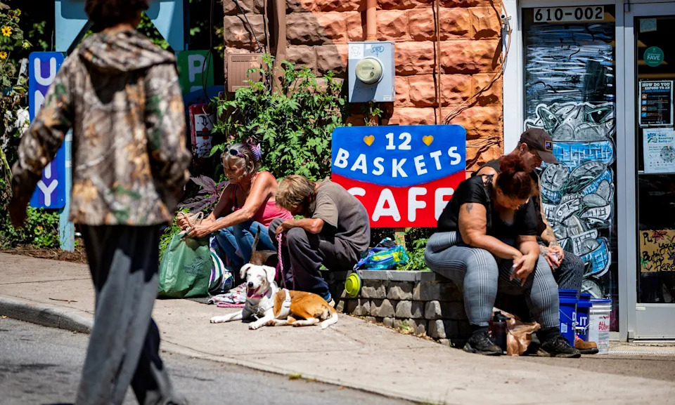 Asheville residents sit outside 12 Baskets in West Asheville, Aug. 25, 2025.