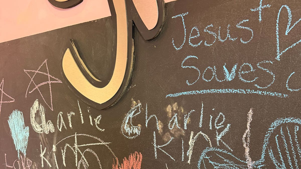 A chalkboard is shown at the frozen yogurt store. Some people wrote on the board, "Charlie Kirk," while others wrote, "Jesus Saves."