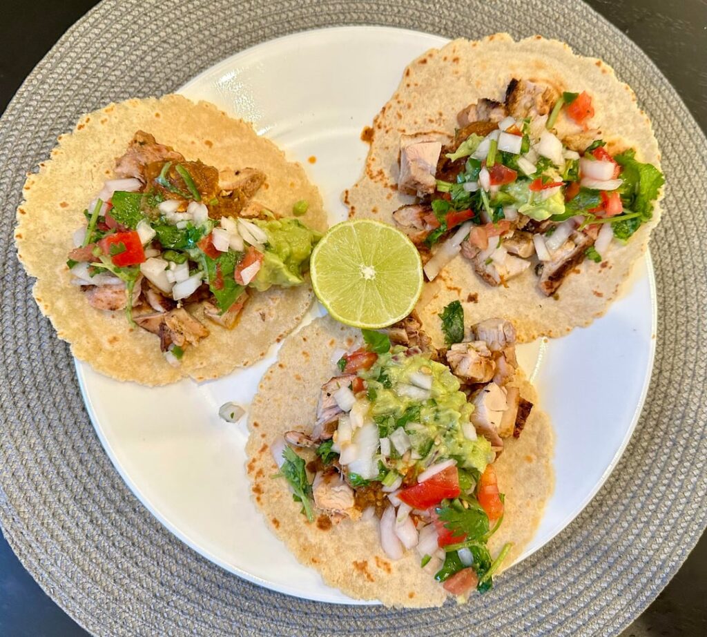 Pollo Asado Tacos with roasted salsa, guacamole, and pico de gallo