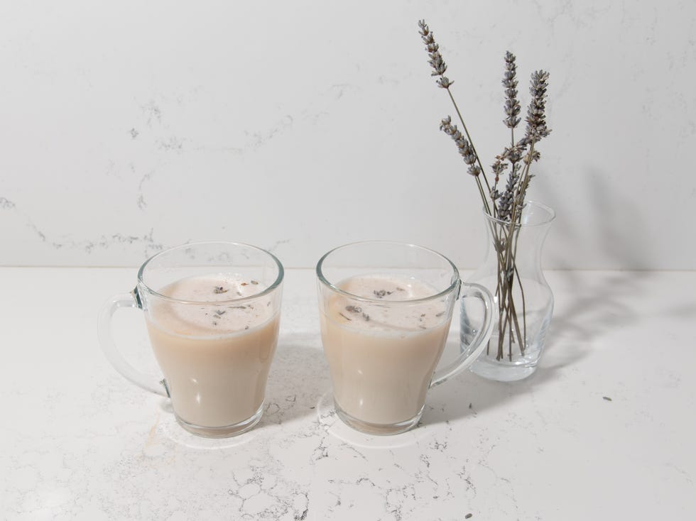 2 mugs of meghan markle lavender grey tea latte with a small bud vase of fresh lavender