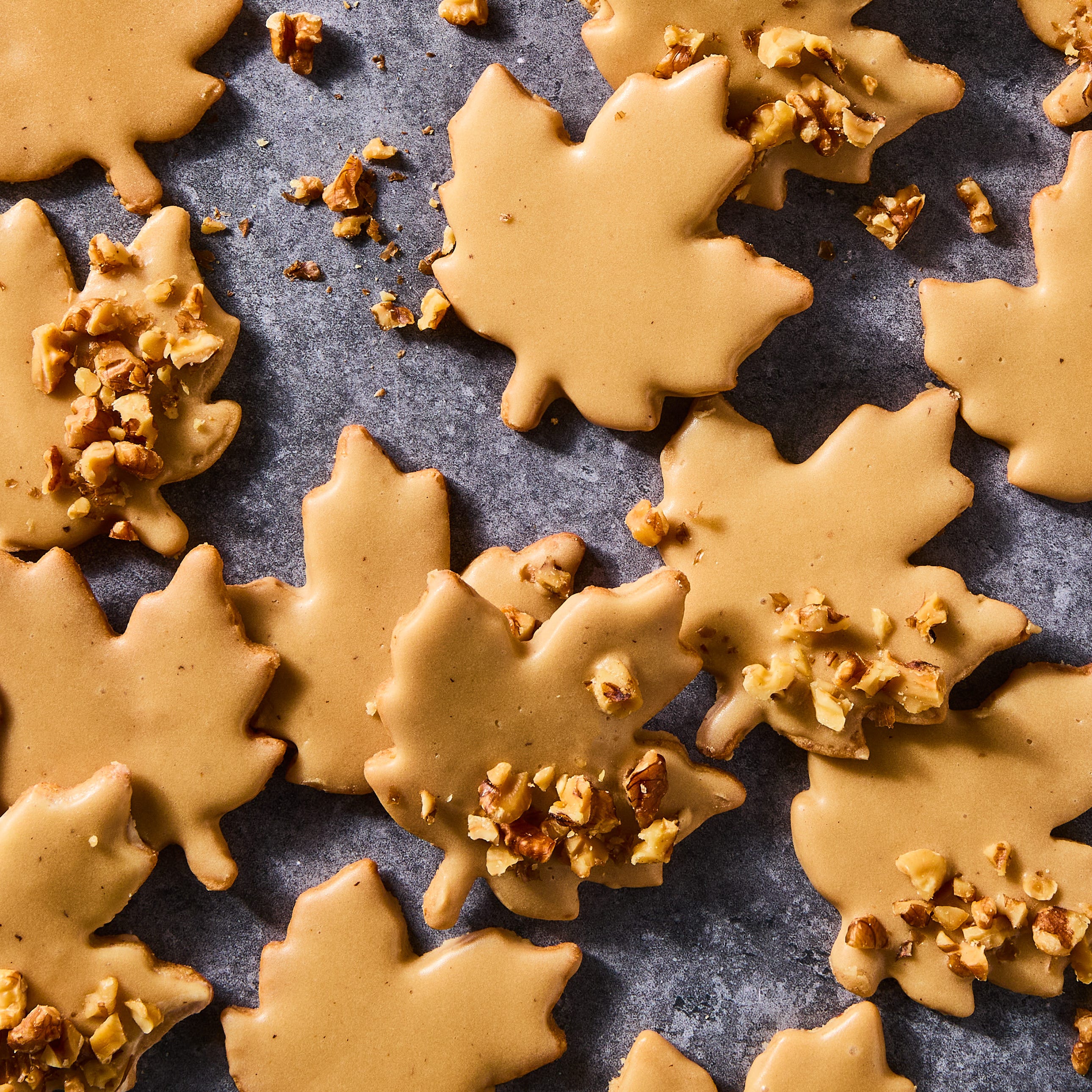 glazed maple leaf cookies topped with pecans