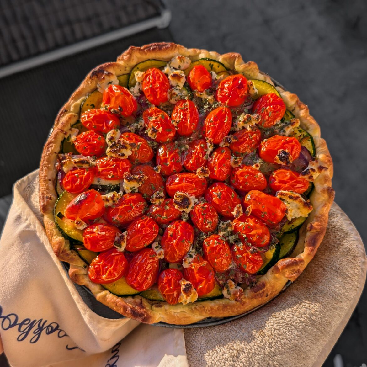 Cherry tomato, red onion, & courgette tart