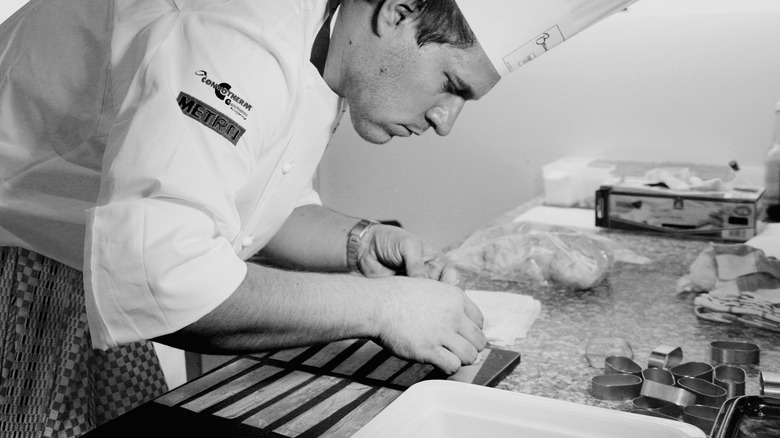 Chef delicately preparing dish