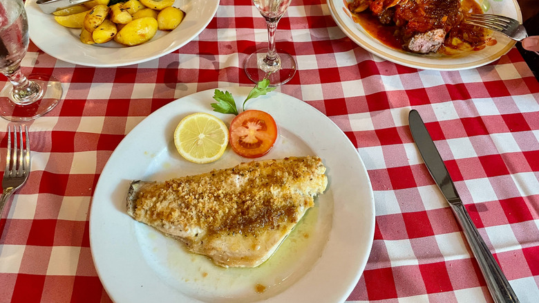 Plates of food on a checkered tablecloth