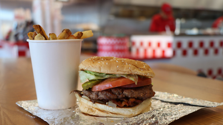 Five Guys burger and fries on a table in the restaurant