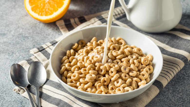 bowl of cereal with milk pouring in