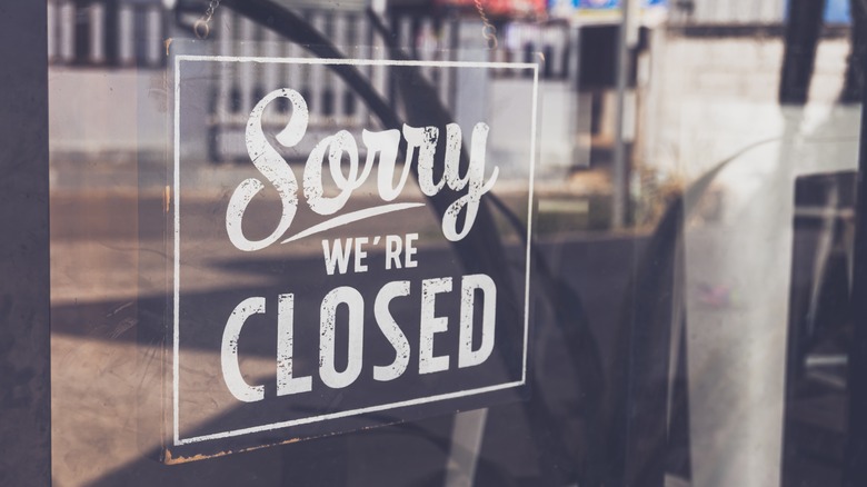 sorry we're closed signage on shop window