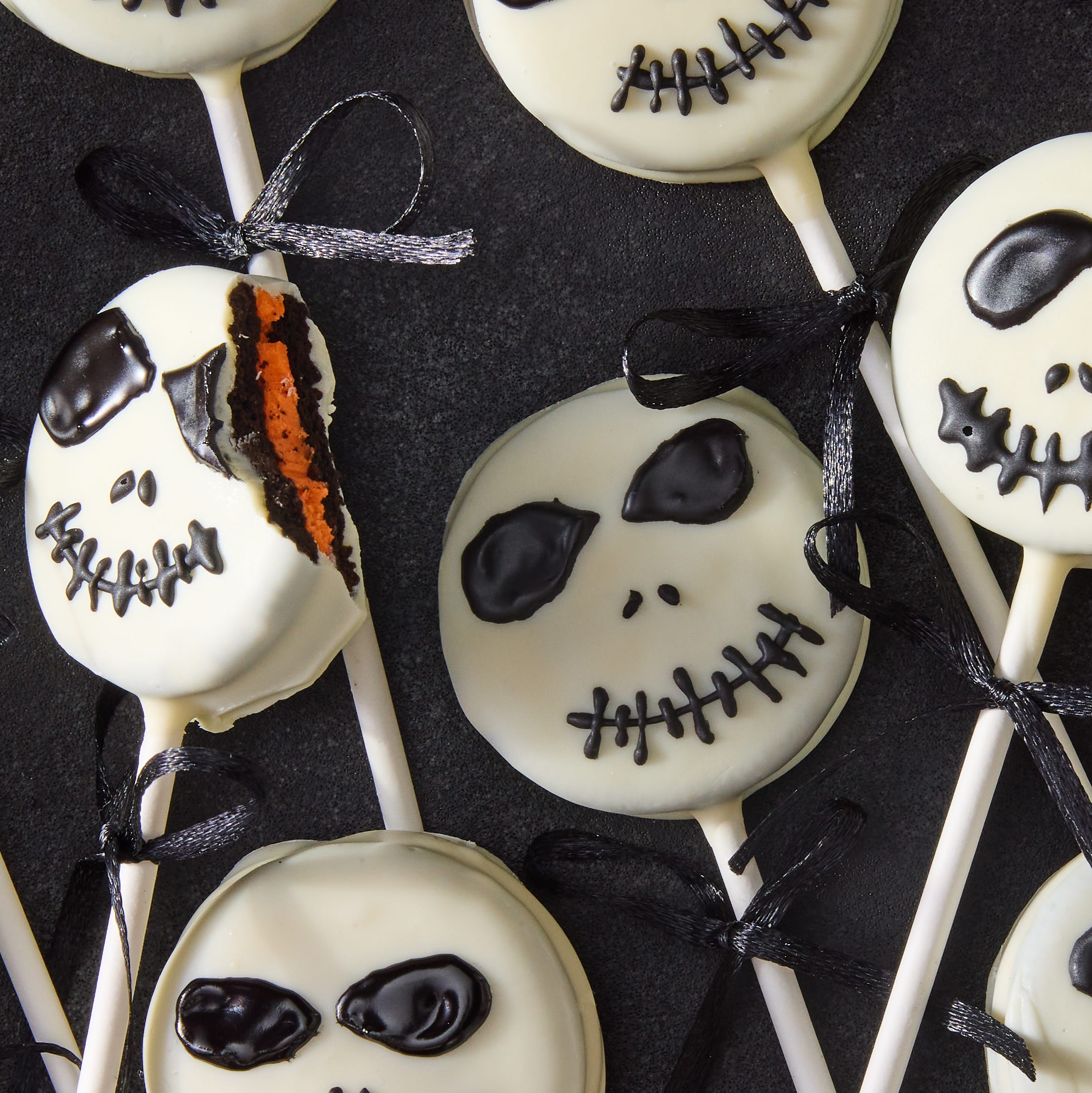 white chocolate covered oreo pops decorated as jack skellington with icing