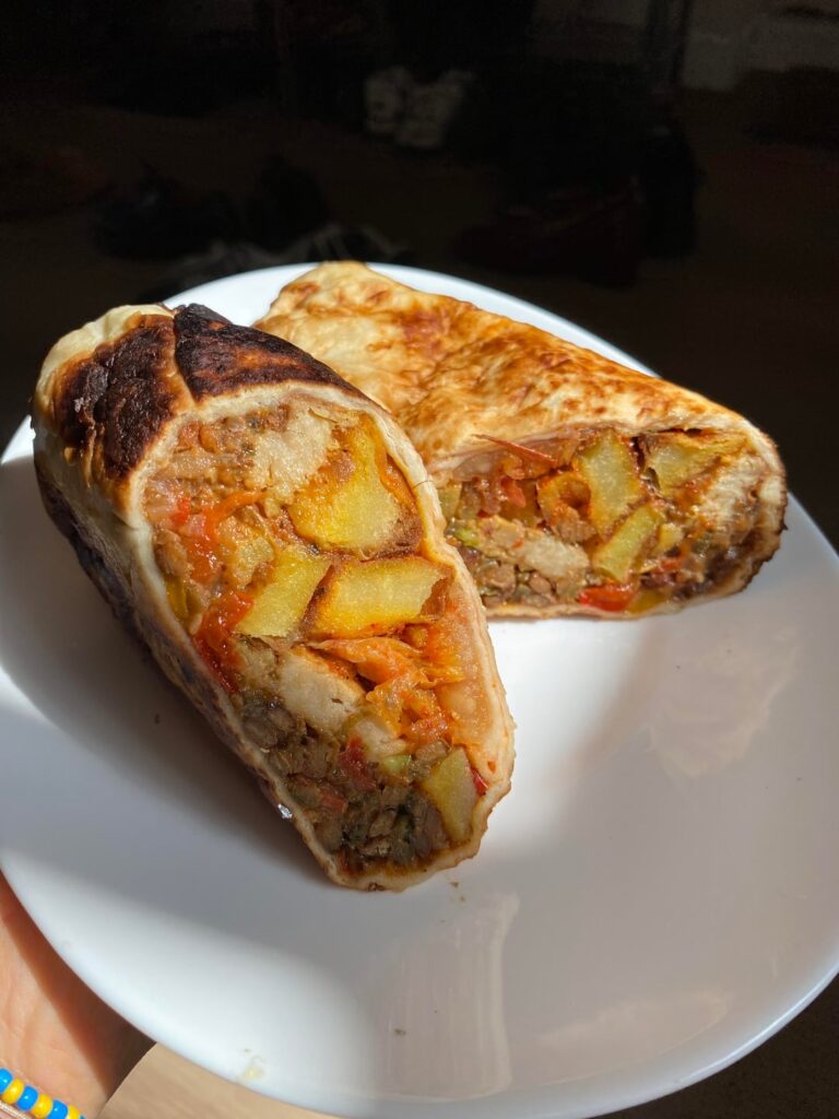 Made some vegan breakfast burritos for my girlfriend to entice her to stay over more often: onion-pepper-garlic cooked to a mush, rosemary roasted potatoes, this is not chicken roast dinner, avocado and kimchi