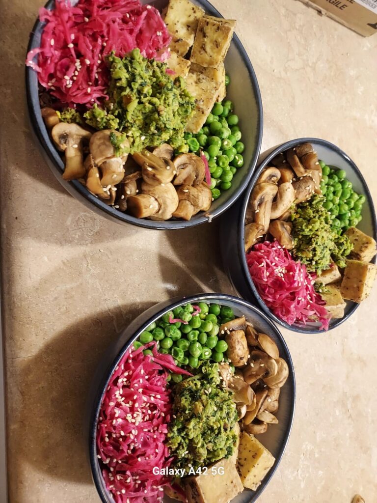 Quinoa bowls with pistachio pea pesto, crispy tofu, steamed peas, balsamic mushrooms, and quick pickled purple cabbage