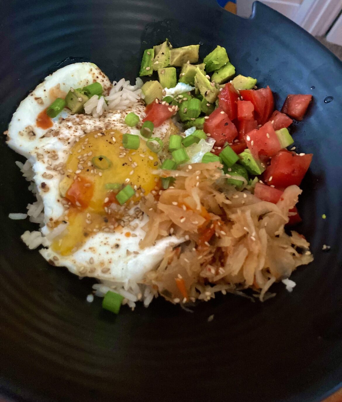 Jasmine Rice, tomato, Avocado and Kimchi topped with sunny side up egg!