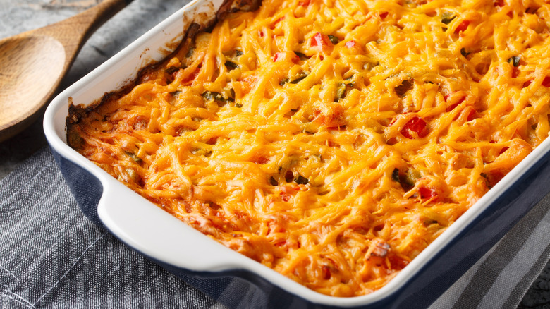 Casserole dish containing food covered with a layer of melted cheese.