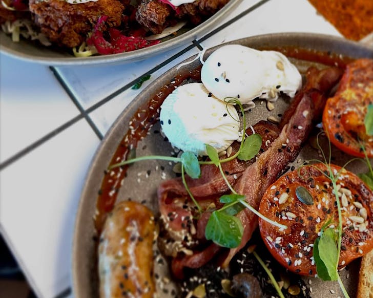 Two plates piled up with the big breakfast from Kneads All Day.