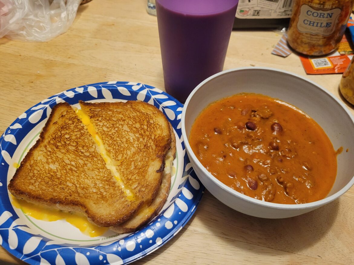 Grilled cheese, chili for dipping, and chocolate milk.