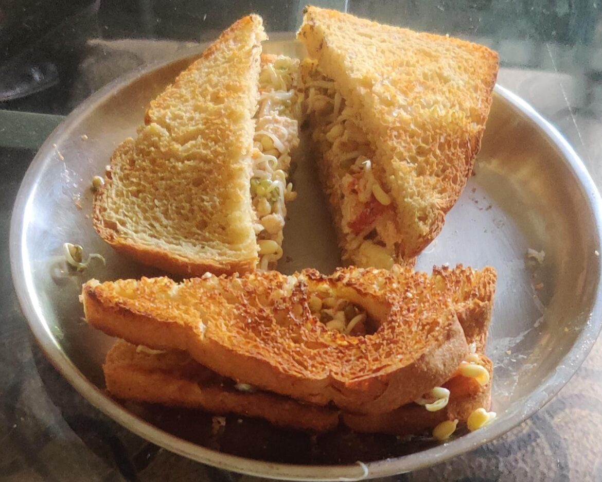 My breakfast today is -Protein bread sandwich containing shallow fried tofu with sprouts-curd salad