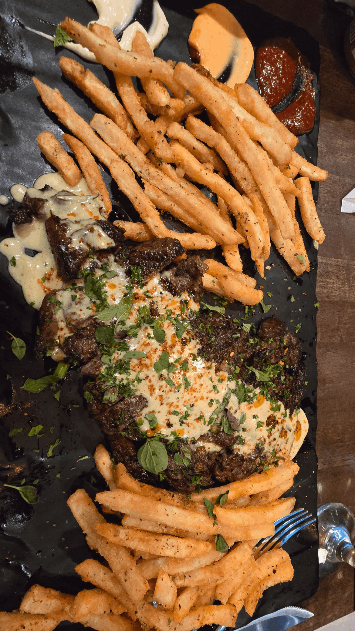 [homemade] steak with fries and a variety of sauces on the side