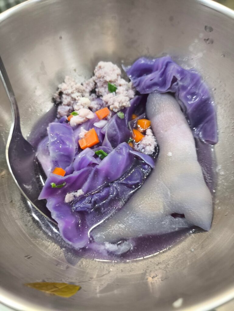 My mom made soup with purple cabbage, minced pork and skin