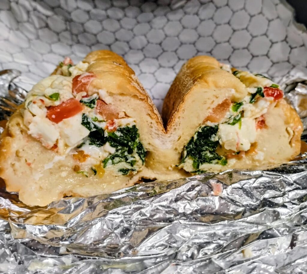 Egg white Greek omelette (spinach, tomato, feta) on a lightly toasted long roll