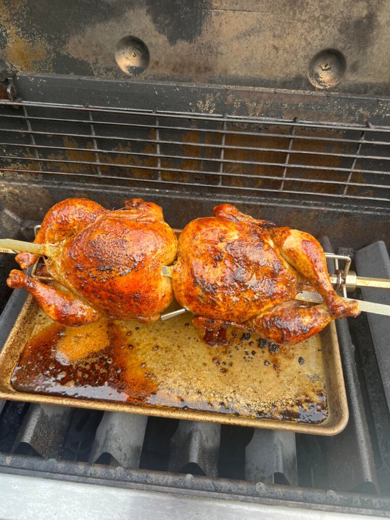 First time making rotisserie chickens on our Weber! They just barely cleared the drippings pan, but came out great.