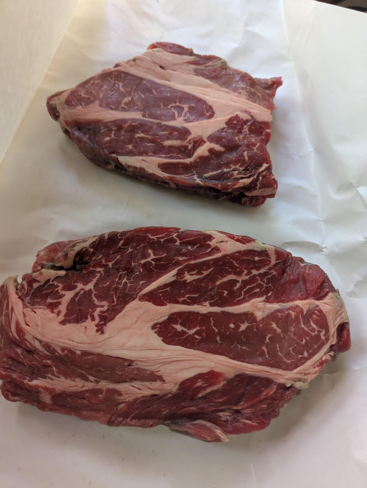Snagged some chuck steaks walking out of work. Was told to cook them hot and fast and they're compatible to ribeye...or should I smoke it?