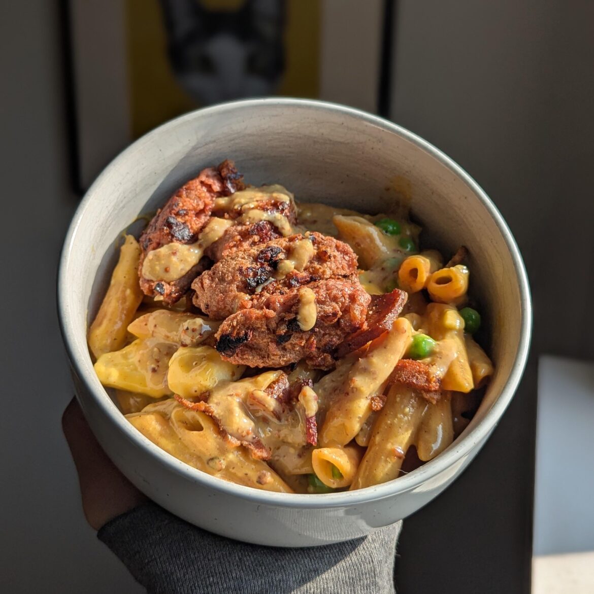 husky boy mac and cheese with peppercorn bacon, seared bratwurst, cheese curds, and maple stoneground mustard.