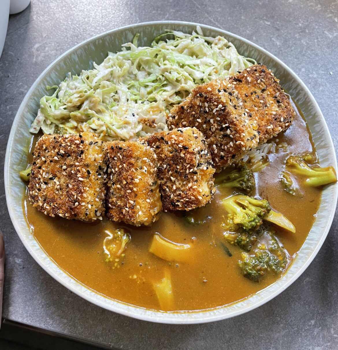 Japanese curry with panko and sesame crusted tofu, rice and sesame slaw