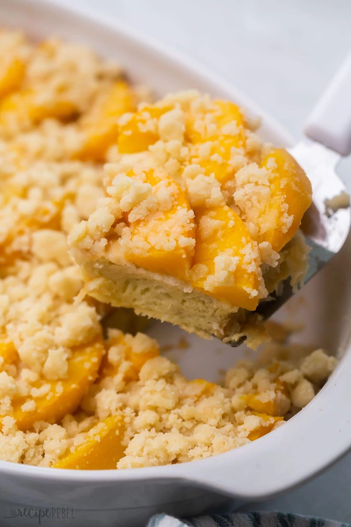These 35 Scrumptious Make Ahead Brunch Casseroles will make your life over the holidays so much easier. Plus, everyone will be delighted with any one of these casseroles for the holidays. Peach cobbler french toast in baking dish.