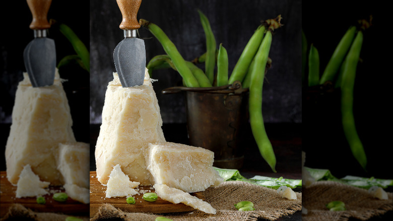 chunks of pecorino romano with broad beans scattered on a cutting board