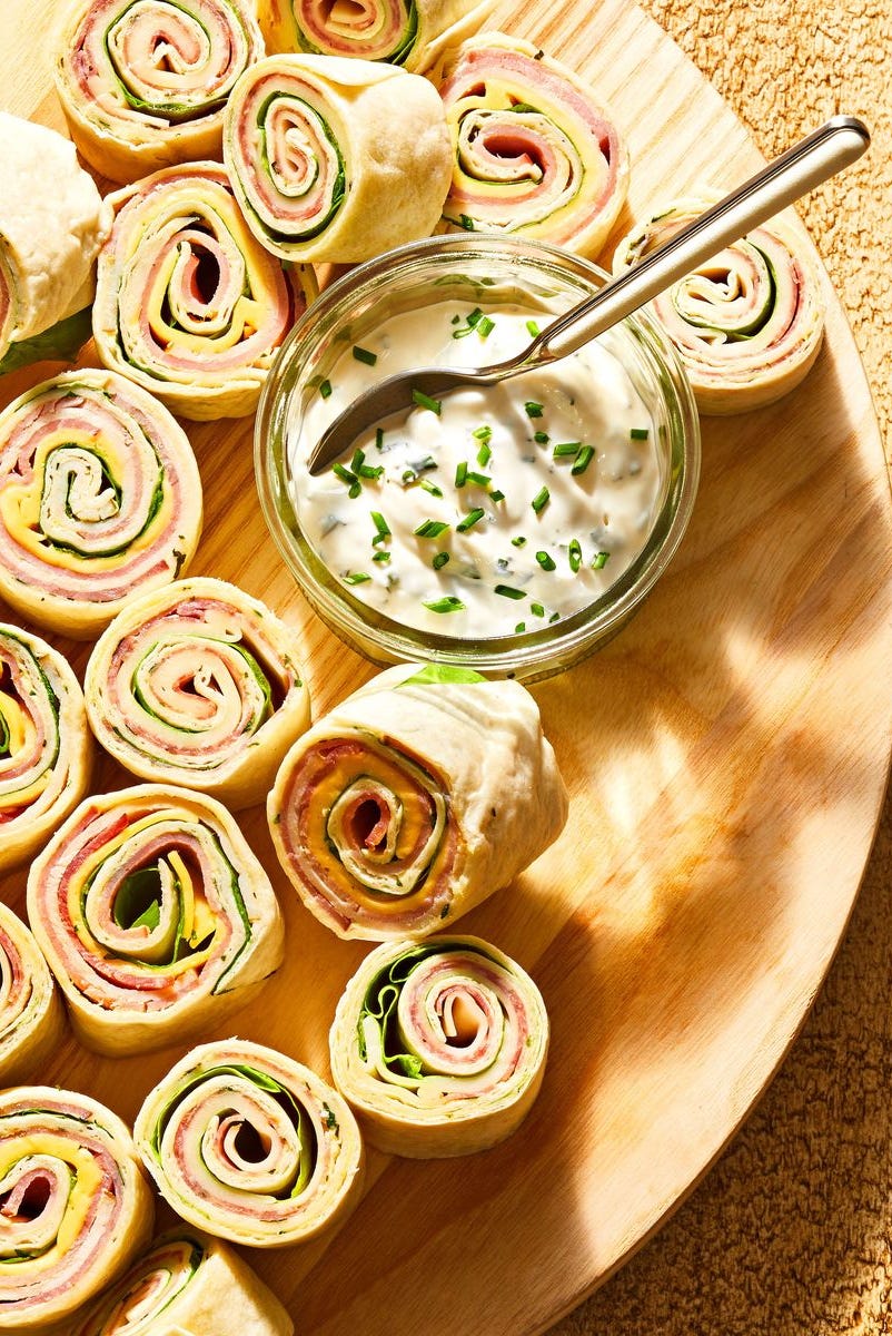 picnic sandwich pinwheels on a wood cutting board