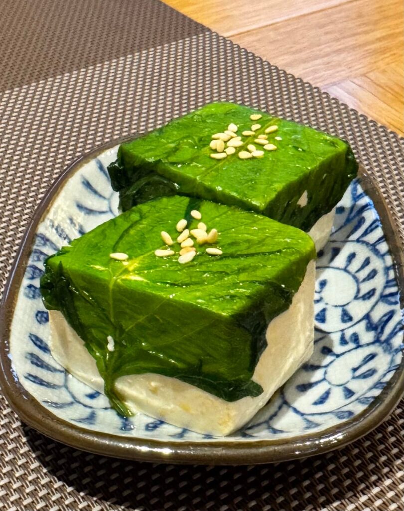 Shiozuke shiso leaf, dipped in ra-yu, then wrapped around tofu.