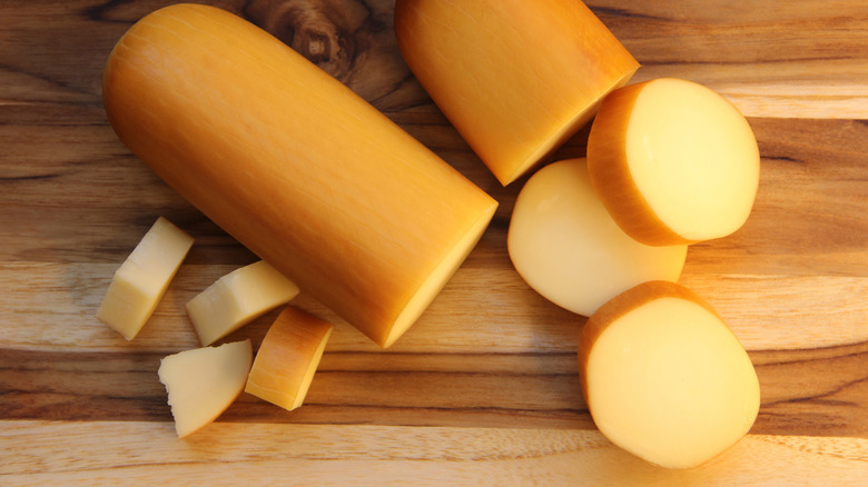 sliced provolone on a wooden cutting board