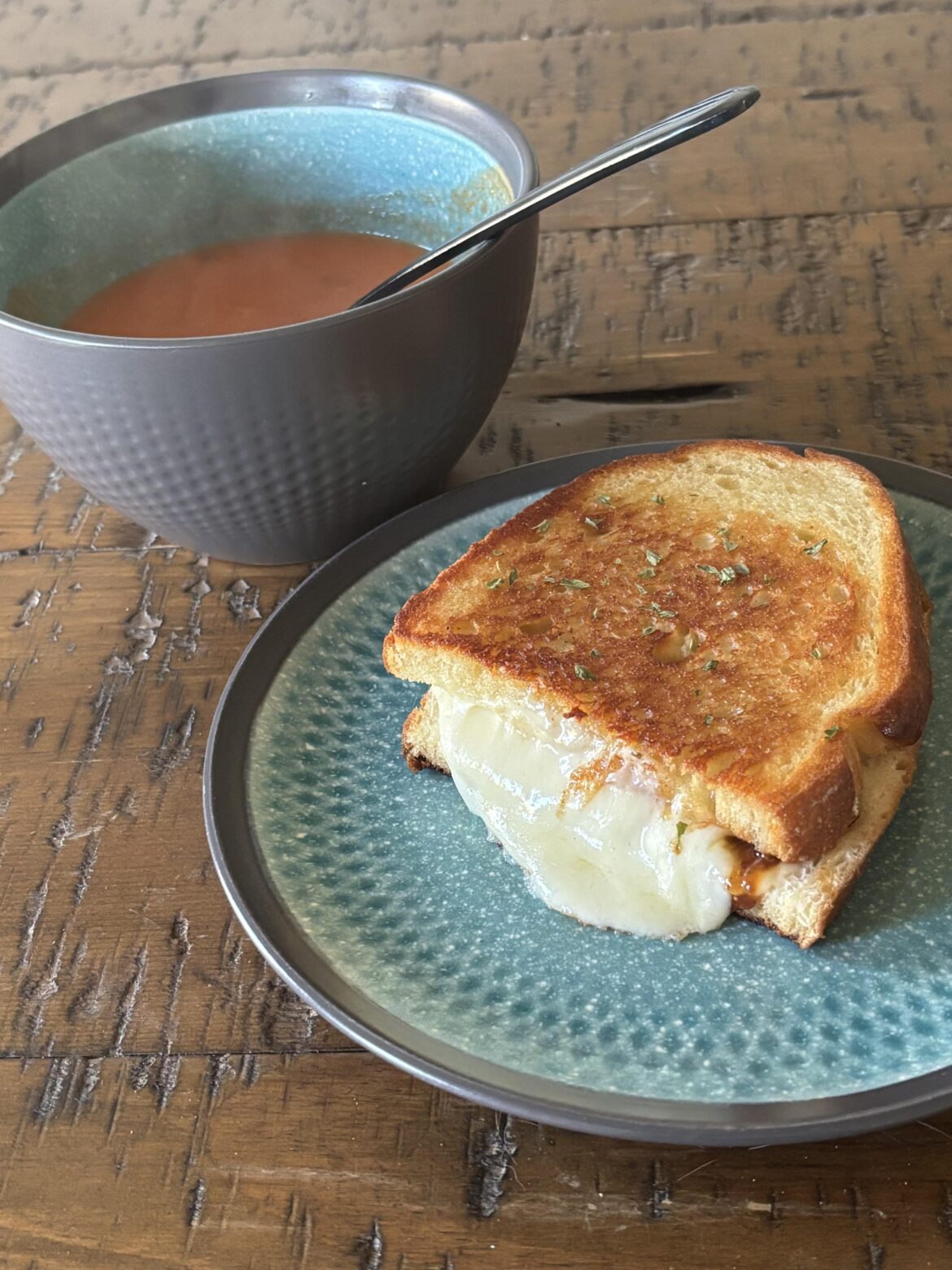 My grilled cheese on sourdough bread- provolone cheese and chili fig spread. With tomato soup on the side of course!