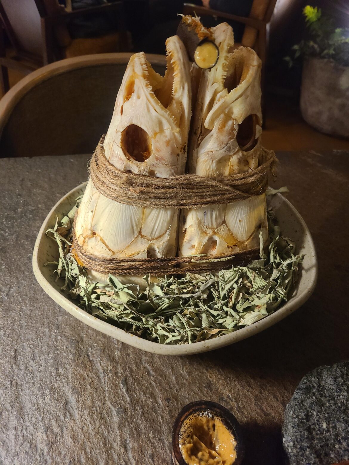 Using fish skulls to prop up my food is a new one for me