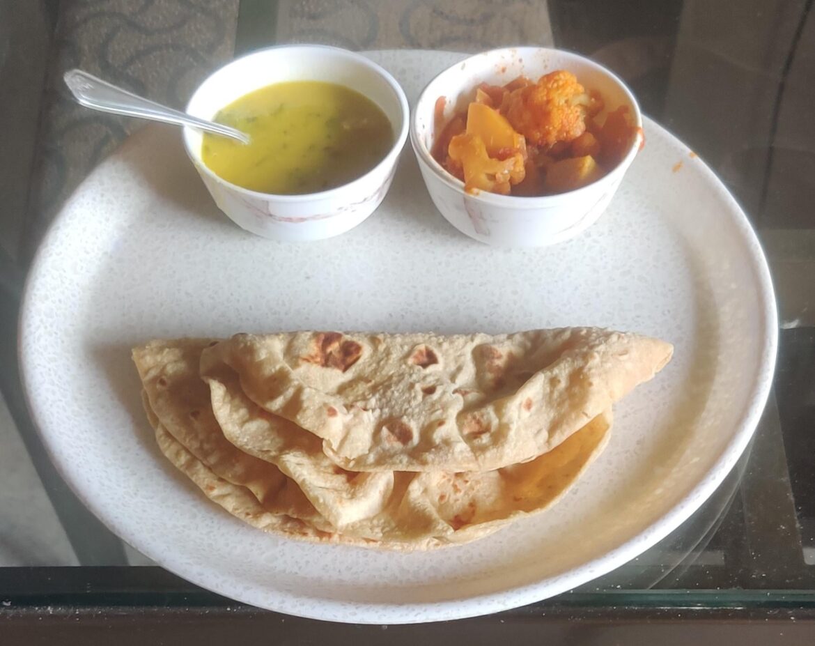 My lunch plate today -Thick dal, Spicy cauliflower and potato curry, and chapati