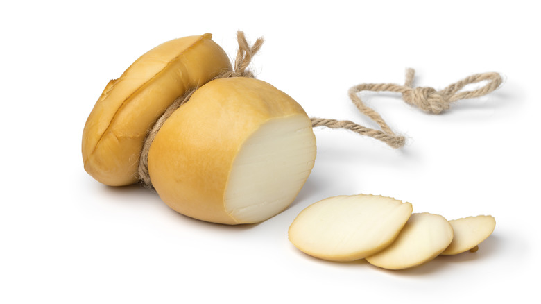 A whole scamorza wheel with slices