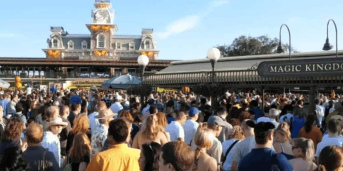 A large crowd of people wait in the security line at Walt Disney World Resort's Magic Kingdom Park