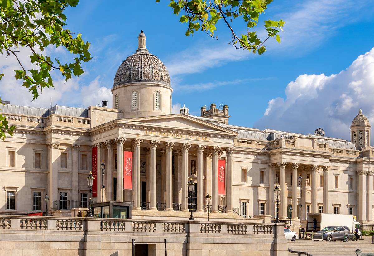 the exterior front entrance of the national gallery in London on a sunny blue sky day