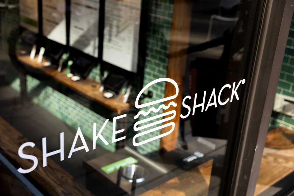 Shake Shack logo on restaurant window.