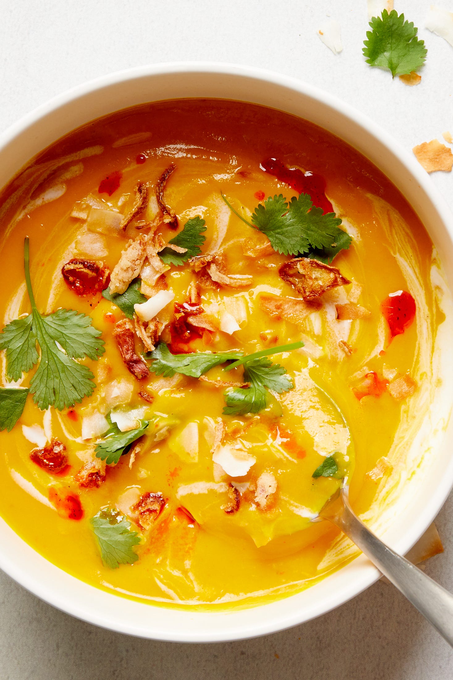 slowcooker vegan butternut squash soup garnished with coconut milk and cilantro