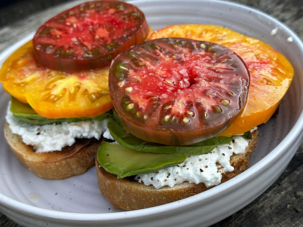 Heirlooms from our garden, avocado, organic cottage cheese on sourdough toast 🤤