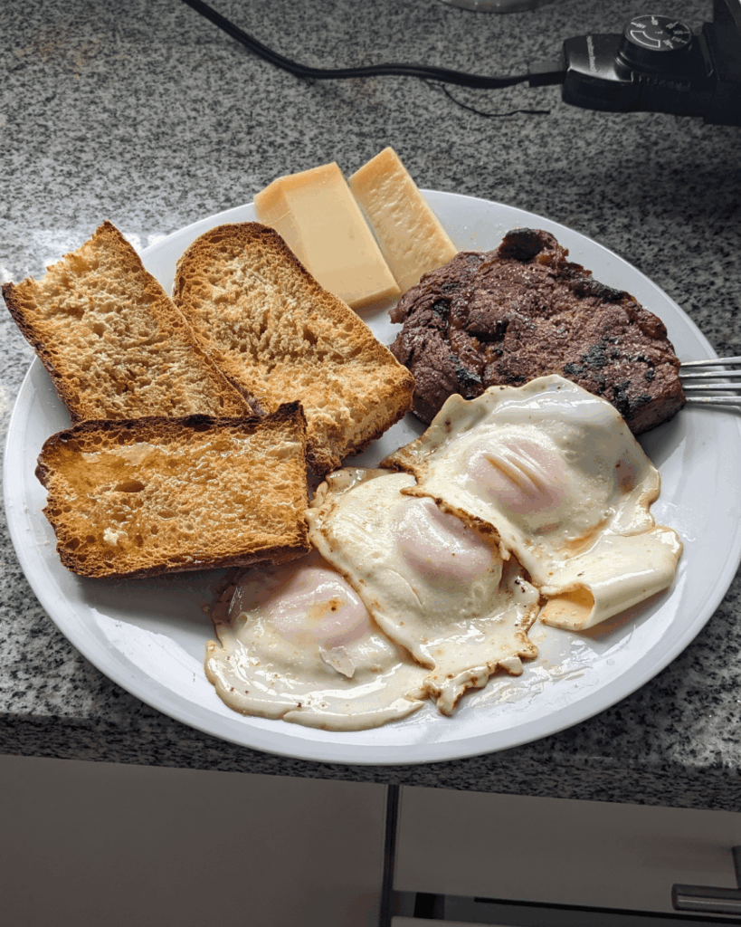 Ribeye with 3 eggs, parmesan cheese, and ciabatta bread.