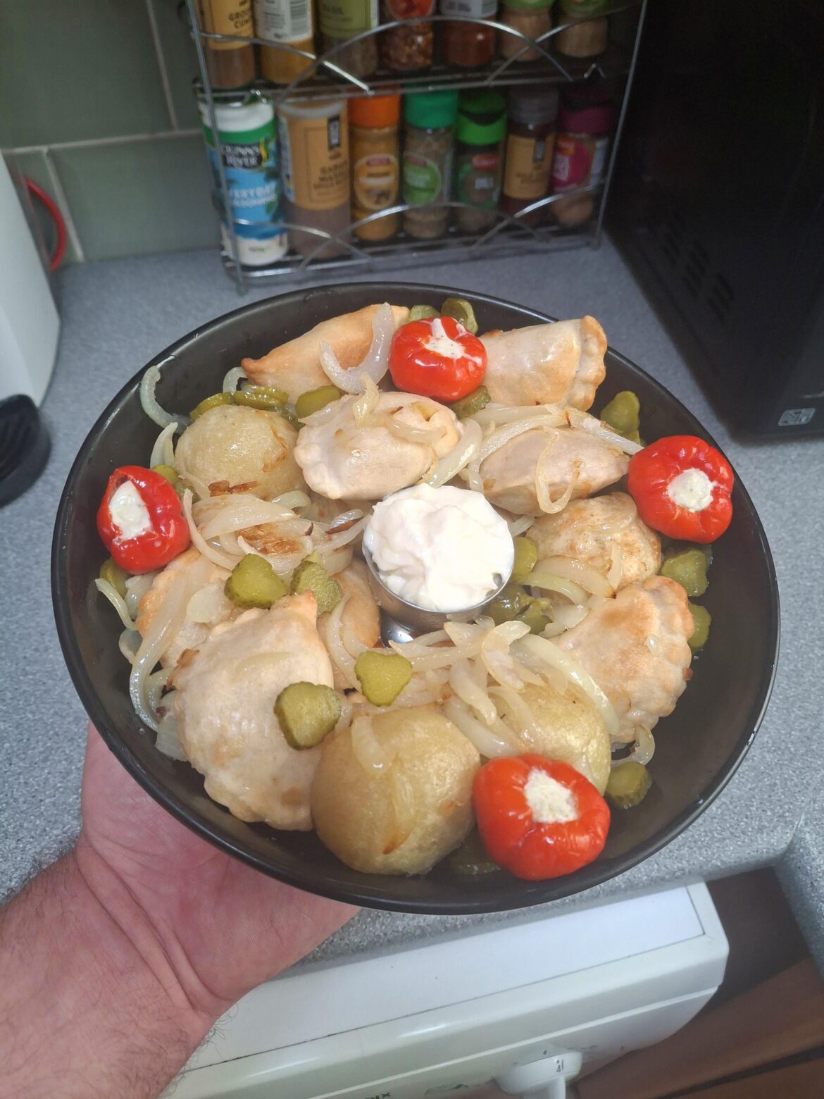 Mixed Polish dumplings in onion butter, with some cheese stuffed pickled peppers